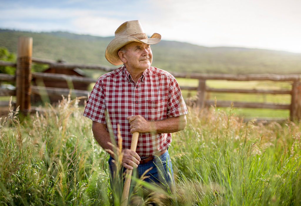 older farmer works the land on his ranch in Colorado