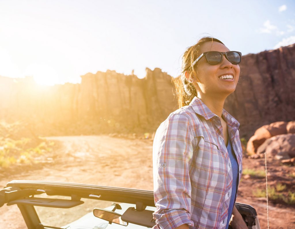 Woman IN Jeep Wrangler In Desert In Moab Utah During Summer Sunset For Lifestyle Photography Campaign.