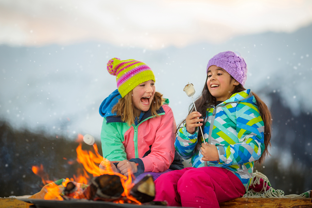 Girls Roast S'Mores at a Fire In Snowmass Colorado Shot By Tyler Stableford For Aspen Snowmass Tourism Campaign In Winter. 