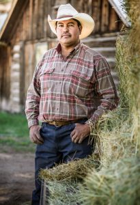 Hardworking Rancher Stands in Front of His Barn after Cutting Hay. Photographer Tyler Stableford Captures Western Life in Images of Sustainable Agriculture.