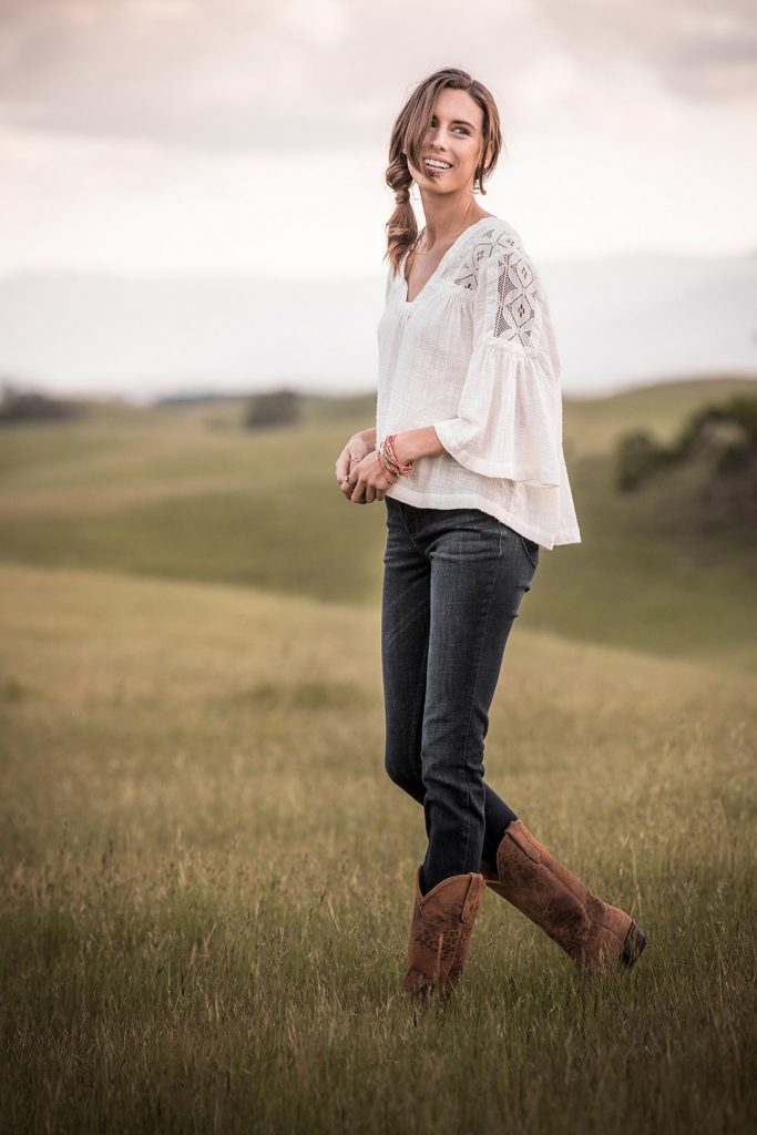 Western Lifestyle And Western Fashion Image Of A Woman On A Ranch At Sunset With Western Clothing.
