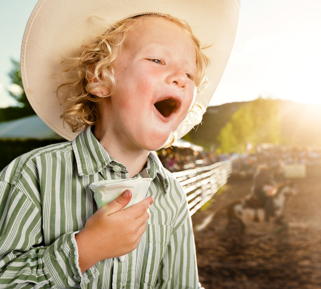 In this Image, the Youngest Rodeo Fan Shouts Encouragement to Bronc Riders at the Snowmass Rodeo. Rodeo is a True Part of Western Life for All Ages.