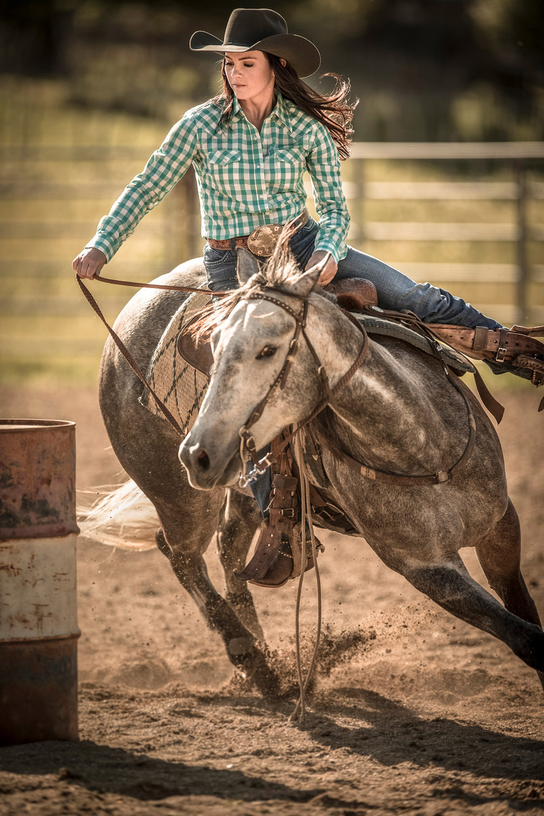 Woman Riding Horse During Barrel Racing Rodeo.