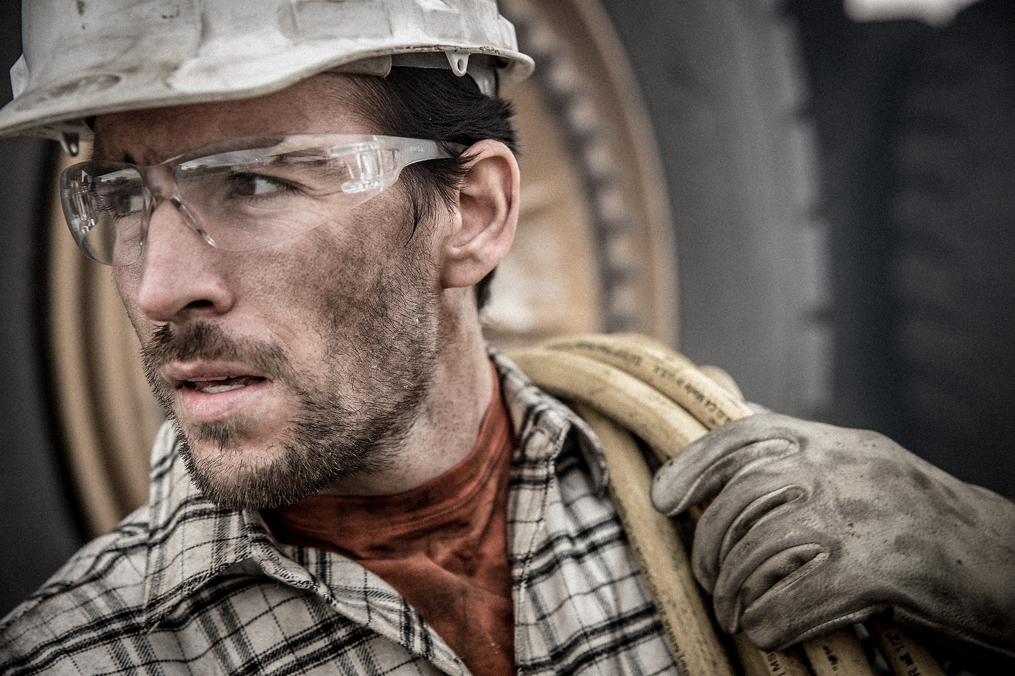 This Professional Photograph of a Modern American Worker in Safety Goggles, Gloves and Hardhat is by a Top Photographer Specializing in Industry Images.
