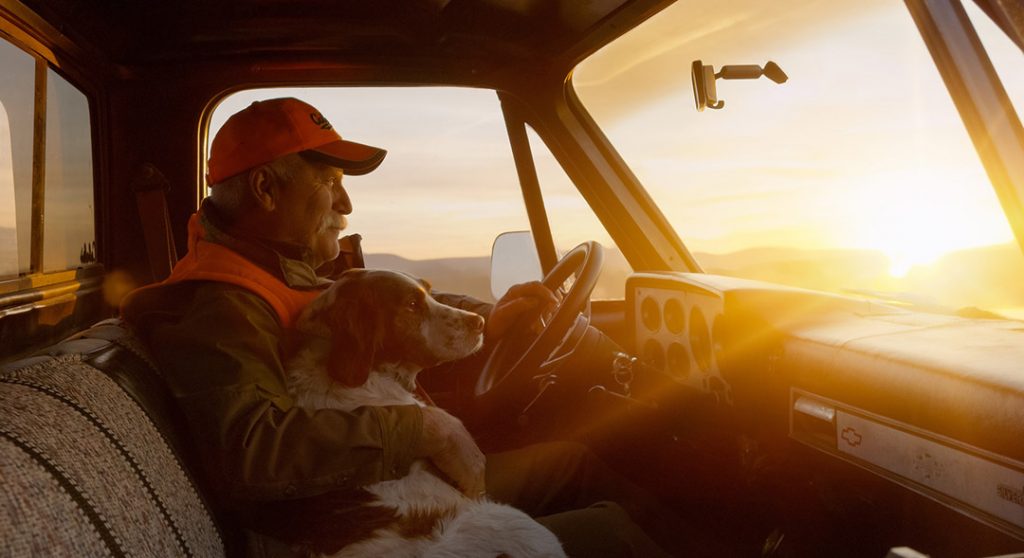 This Poignant Image Captures the Satisfaction of a Lifelong Hunter Returning from a Trip at Sunset with His Dog.