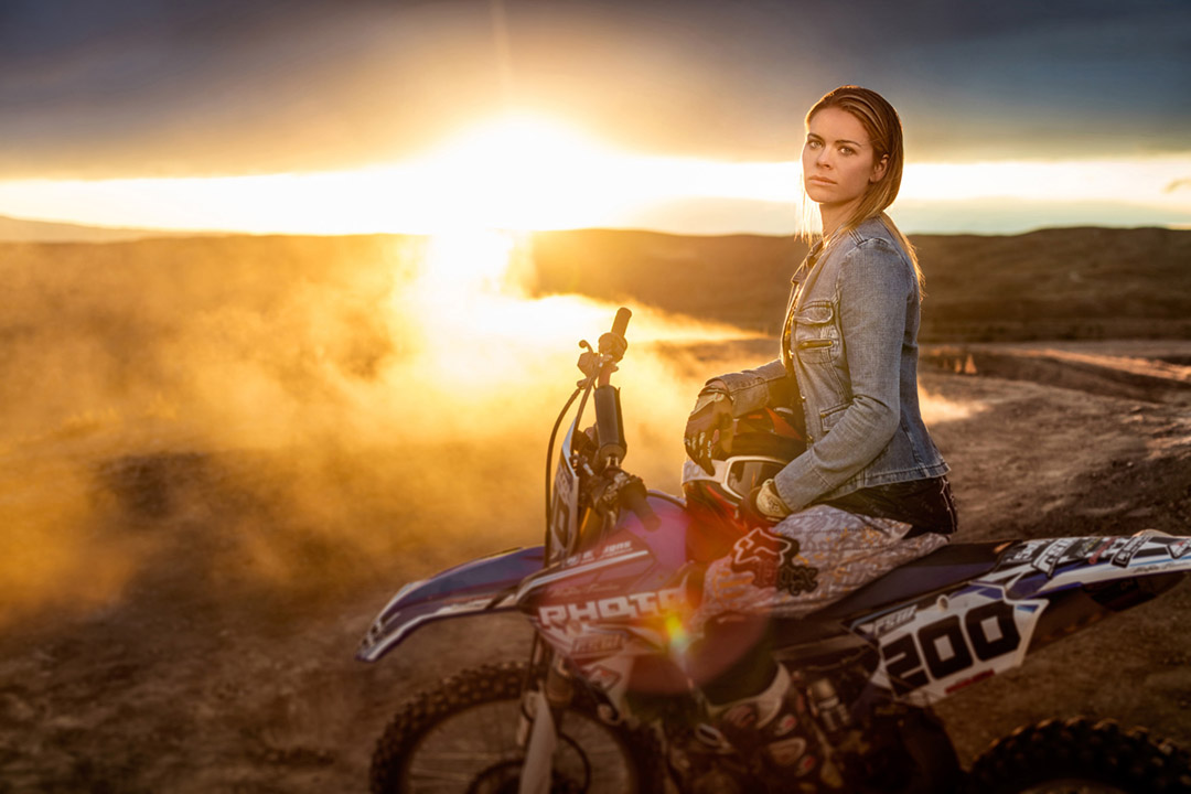 This image of a female extreme athlete sitting on her dirt bike is part of a photo series about athletes and outdoor adventurers. 