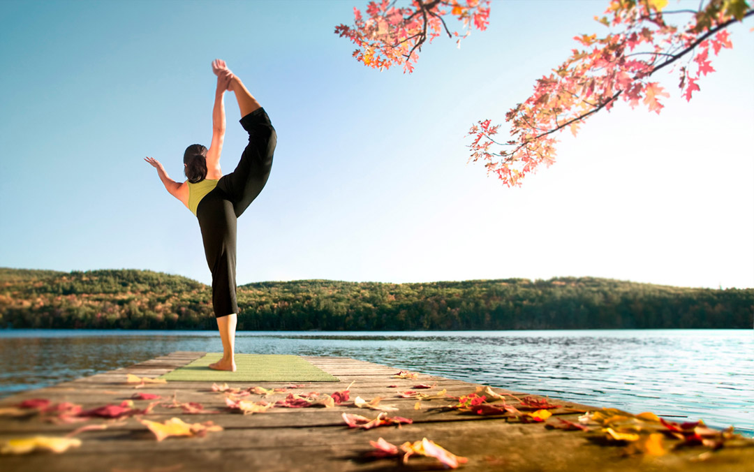 This Fine Art Portrait Shows an Athletic Woman Performing a Yoga Balance Pose on a Floating Dock by a Lake. Yoga is Part of Her Active Lifestyle.