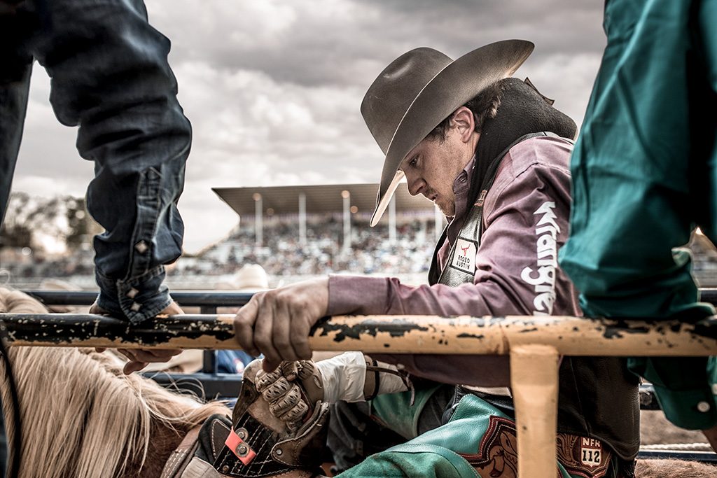 professional saddle bronc rider in the chute for wrangler jeans. 