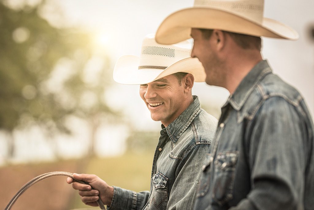 wrangler athletes cowboys rope cattle on a ranch in texas. 