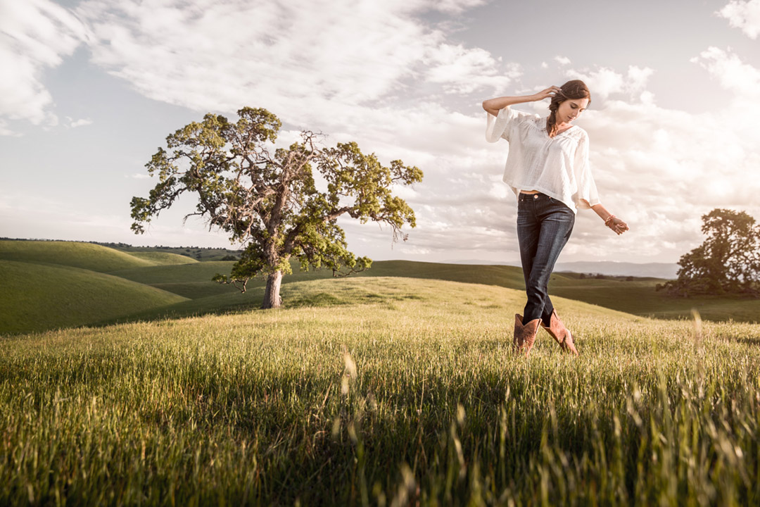 Woman in A Field Wearing Wrangler Jeans For A Sunset Shoot.