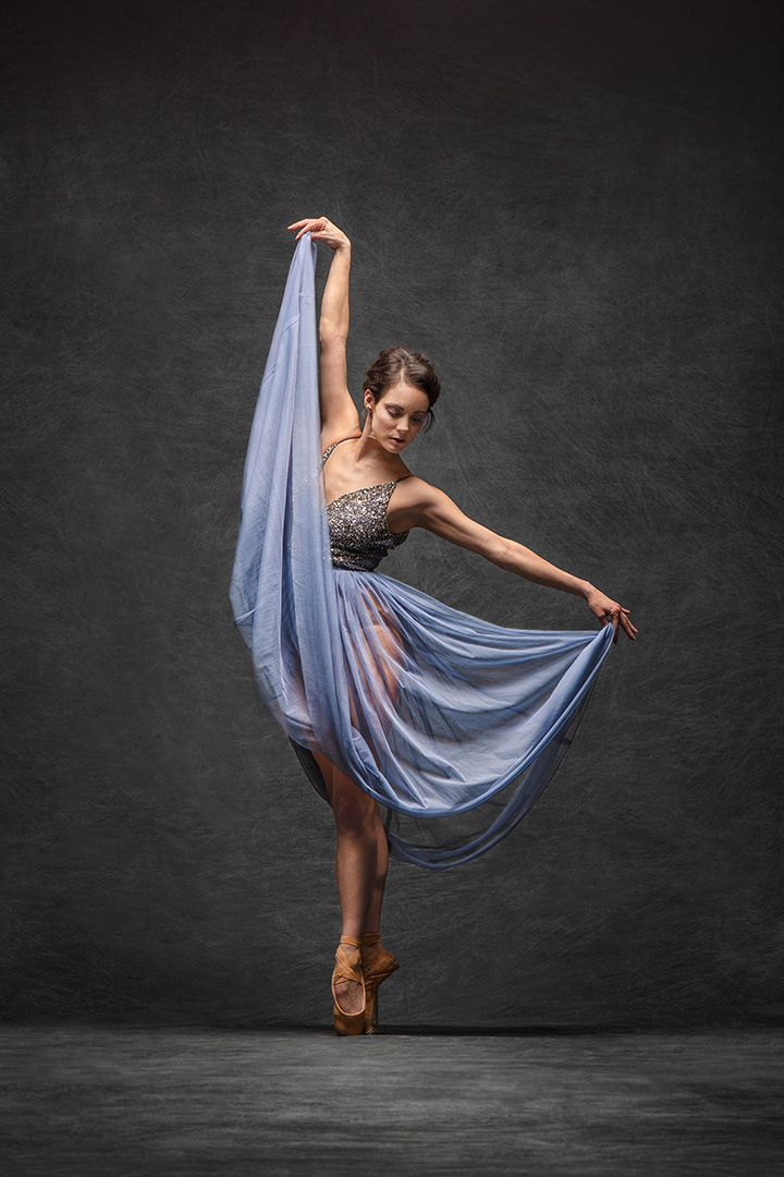 Female Ballet Dancer In Blue Dress Standing On Pointe 