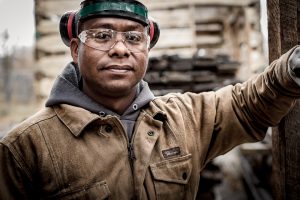 Portrait of mill worker at reclaimed wood mill.