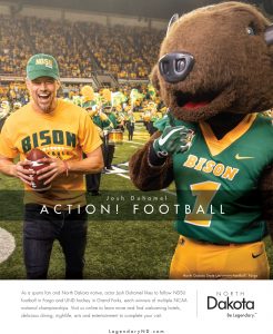 Josh Duhamel holds a football on the field next to the North Dakota State Bisons mascot.